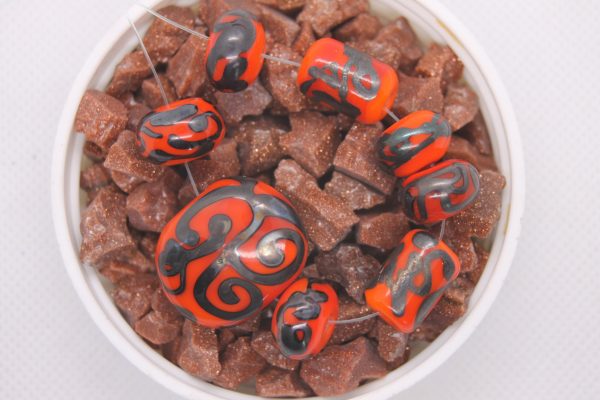Metallic Black on Reddish-Orange Base